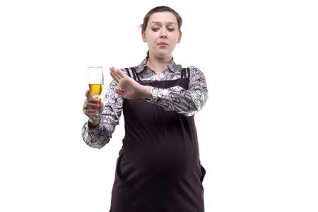 Pregnant woman looking at alcohol on white backgroundの写真素材