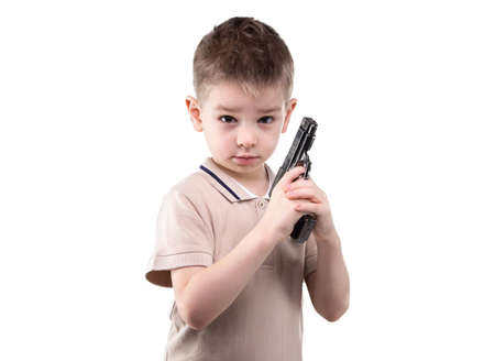 Serious cute little boy with the gun on white backgroundの写真素材