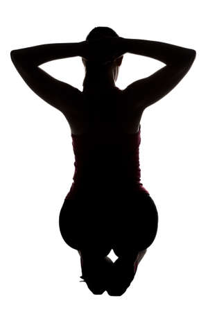 Silhouette of sporty woman, squatting from back on white backgroundの写真素材