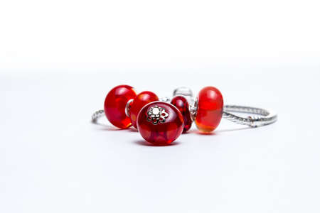 Bracelet with red glass beads on white backgroundの写真素材