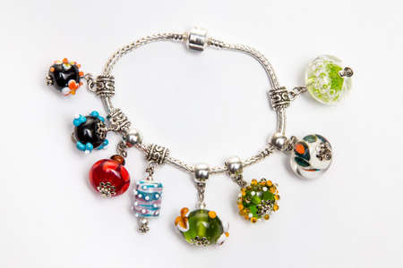 Jewelry with red and blue glass beads on white backgroundの写真素材