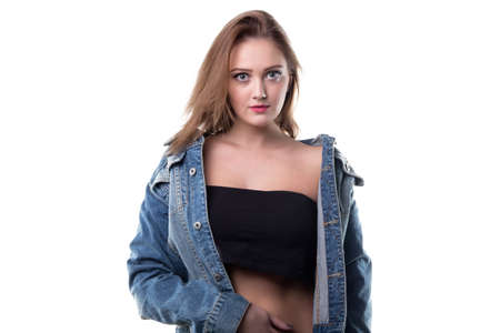 Blond young woman in jeans jacket on white backgroundの写真素材