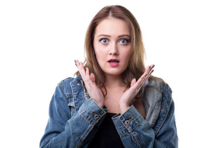 Surprised woman in jeans jacket on white backgroundの写真素材