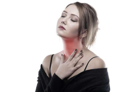 Blond woman with sore throat on white backgroundの写真素材
