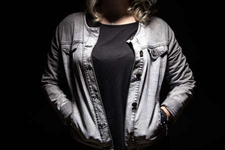 Woman's hands in the pockets on black backgroundの写真素材