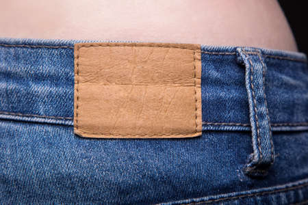Empty leather label and jeans on white backgroundの写真素材