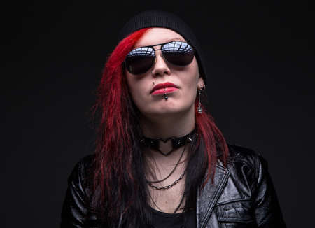 Informal woman with sunglasses on black backgroundの写真素材