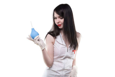 Brunette frowned nurse with medical enemaの写真素材