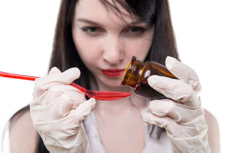Nurse dripping liquid mixture on white backgroundの写真素材