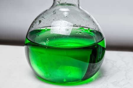 Green liquid in glass flaskの写真素材