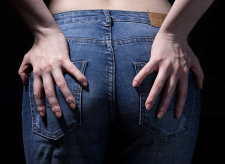 Buttocks and hands on blue jeansの写真素材