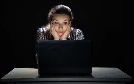 Scared woman watching interesting movieの写真素材