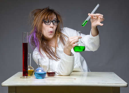 Grimacing working scientist with glass flaskの写真素材