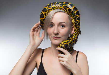 Blond woman and snake on her headの写真素材