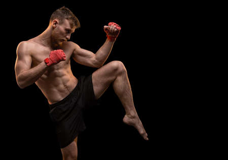Muscular young man with leg upの写真素材