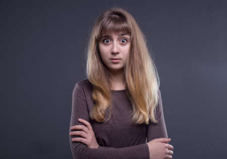 Puzzled blond teenage girlの写真素材