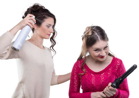 Working hairstylist with hairsprayの写真素材