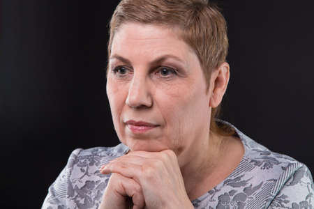 Portrait of sitting old woman looking side