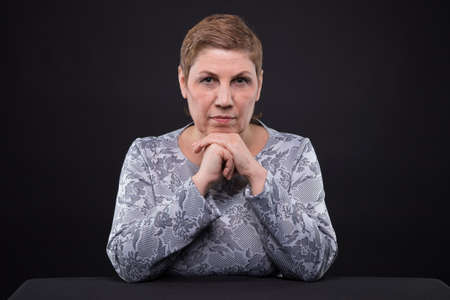 Portrait of sitting senior womanの写真素材