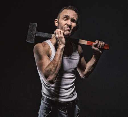 Scratching face man with hammerの写真素材