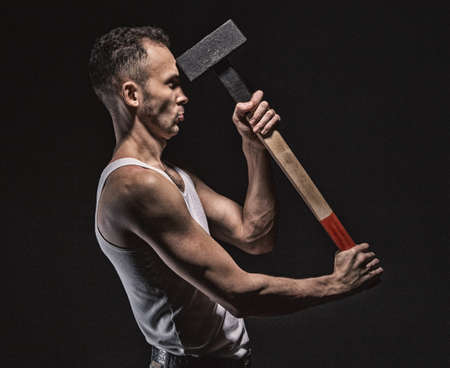 Man hits himself with hammerの写真素材