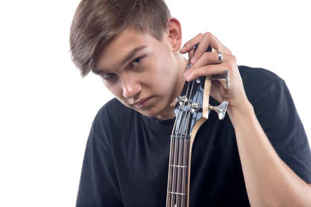 Photo of teenager with bass guitarの写真素材