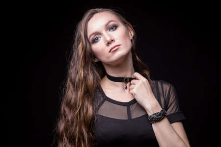 Young blond woman with long hair and chokerの写真素材