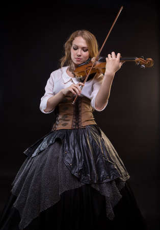 Blond young woman playing the fiddleの写真素材