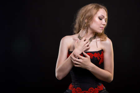 Young blond girl wearing dress with red embroideryの写真素材