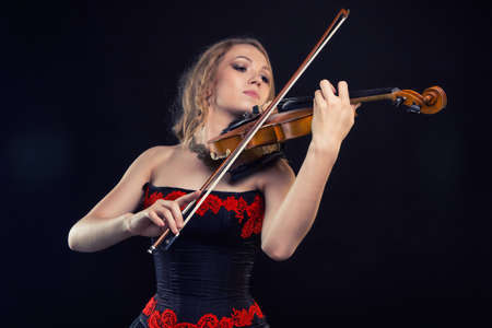 Girl in dress playing the fiddleの写真素材
