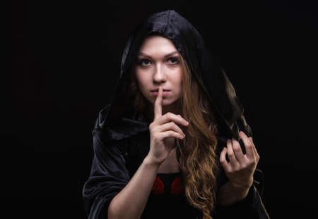 Blond girl in hood showing quiet gesture