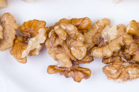 Brown walnuts on white plate