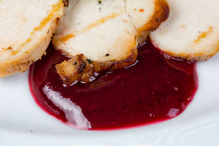 Slices of fried ham and berry sauceの写真素材