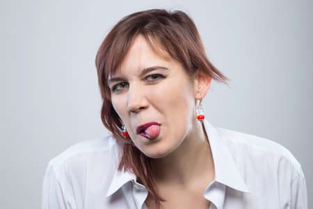 Portrait of young grimace womanの写真素材
