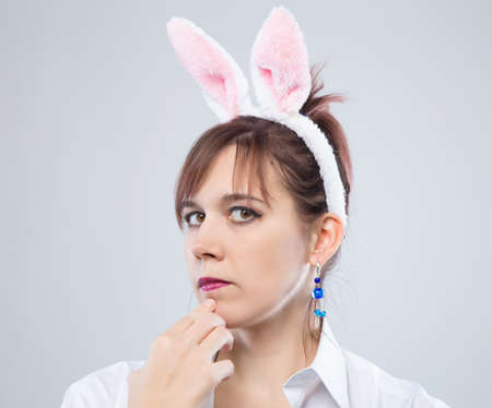 Thoughtful woman with bunny ears