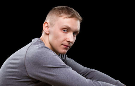 Young blond man isolated on blackの写真素材