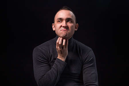 Puzzled young manの写真素材