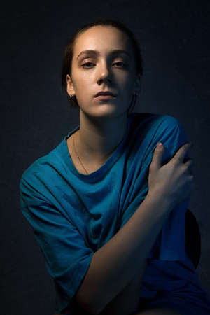 Photo of young woman portrait in shadowsの写真素材