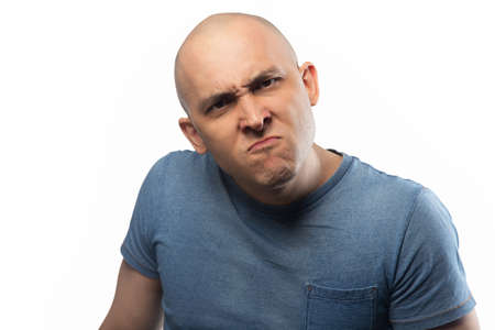 Photo of the angry frowning bald manの写真素材