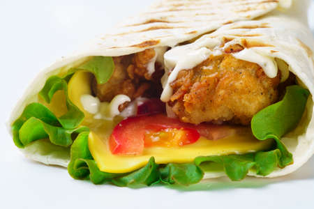 Grilled chicken pita with vegetables on white backgroundの写真素材