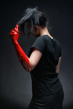 Photo of woman with red hand pulling hairの写真素材