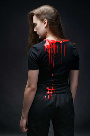 Photo of woman with red paint on neckline