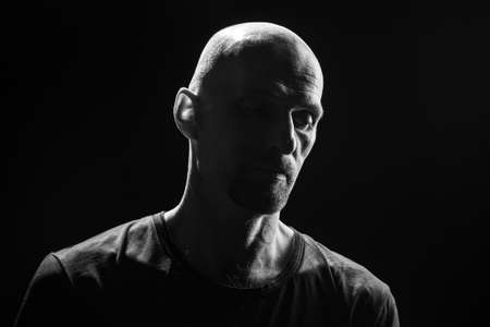 Black and white portrait of the bald man on black backgroundの写真素材