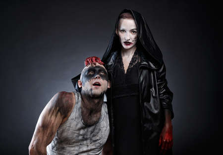 Bald mad man and scary woman with blood handsの写真素材