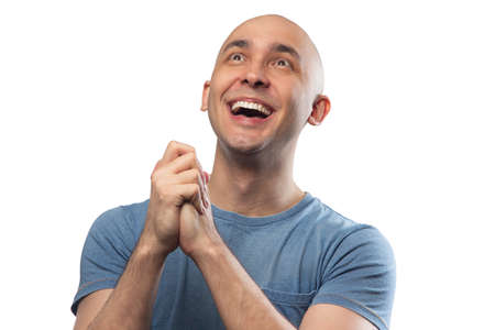 Photo of young bald winning man in tee shirt
