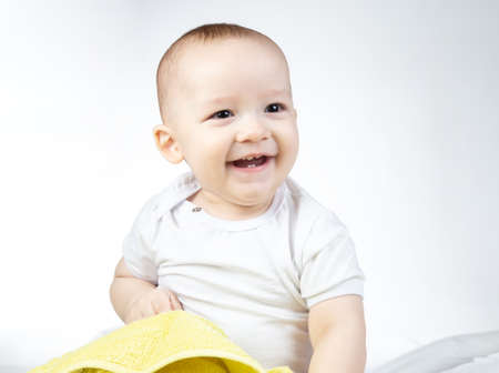 Photo of smiling eleven-month-old baby on a white background