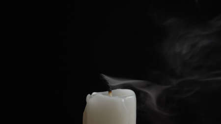 Shot of smouldering wick and smoky cloud on black backgroundの写真素材