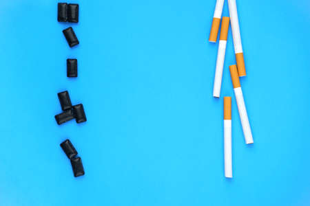 Shot of blue background with cigarettes and black gum pads