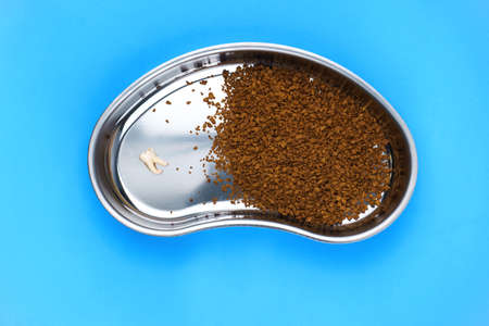 Image of kidney-shaped bowl with coffee on blue background