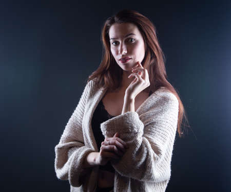 Image of young woman with long hair in shadows